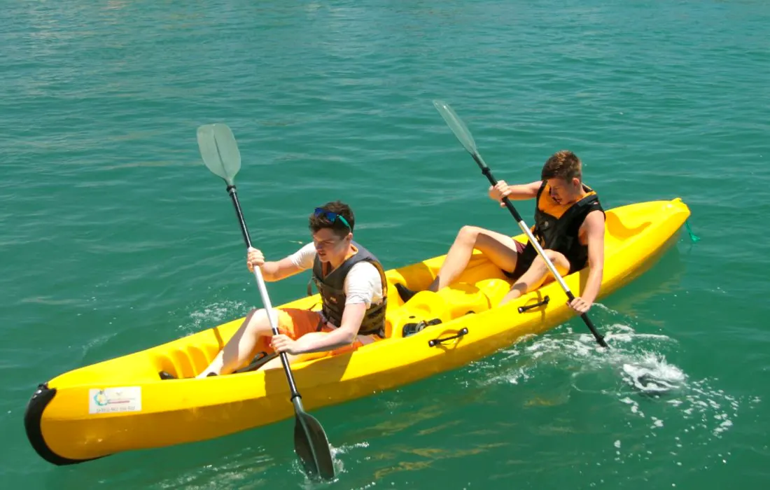 Two paddlers sharing a double kayak in the Ria Formosa
